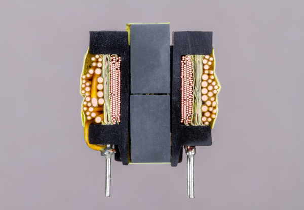 A small power supply transformer, with different windings of wire visible